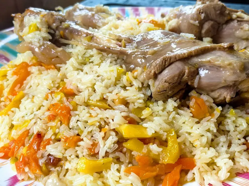 Xinjiang clay-pot pilaf with rice, carrot and lamb served in a small restaurant