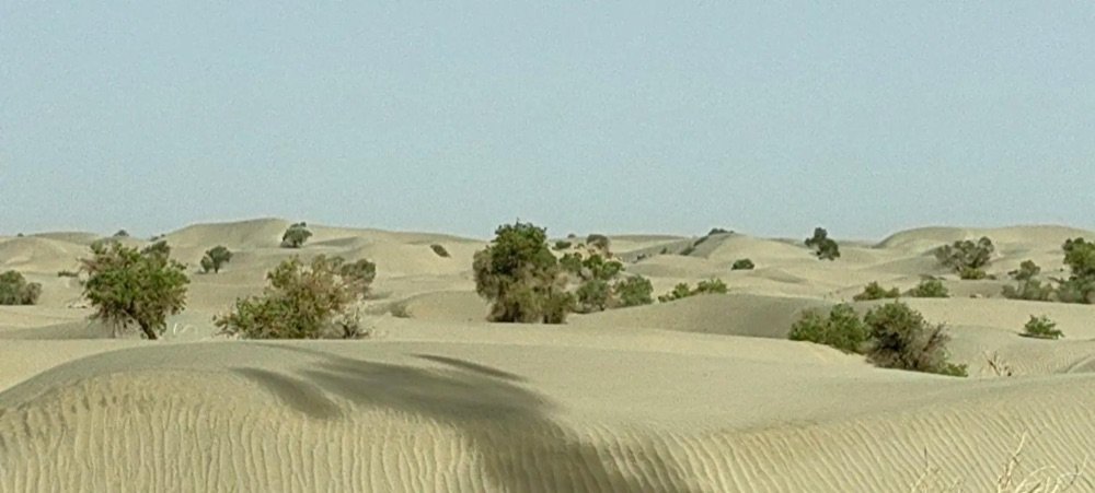 Panoramic view from the northern stupa mound at Jiaohe Ancient City, overlooking the Turpan Basin and distant Flaming Mountains