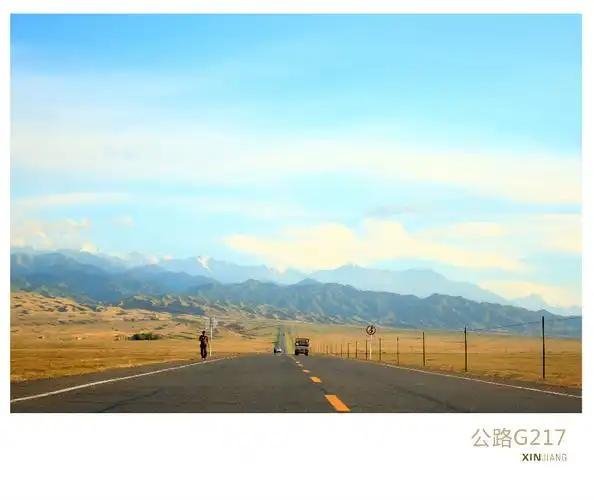 A vehicle on a remote Xinjiang highway crossing open desert terrain